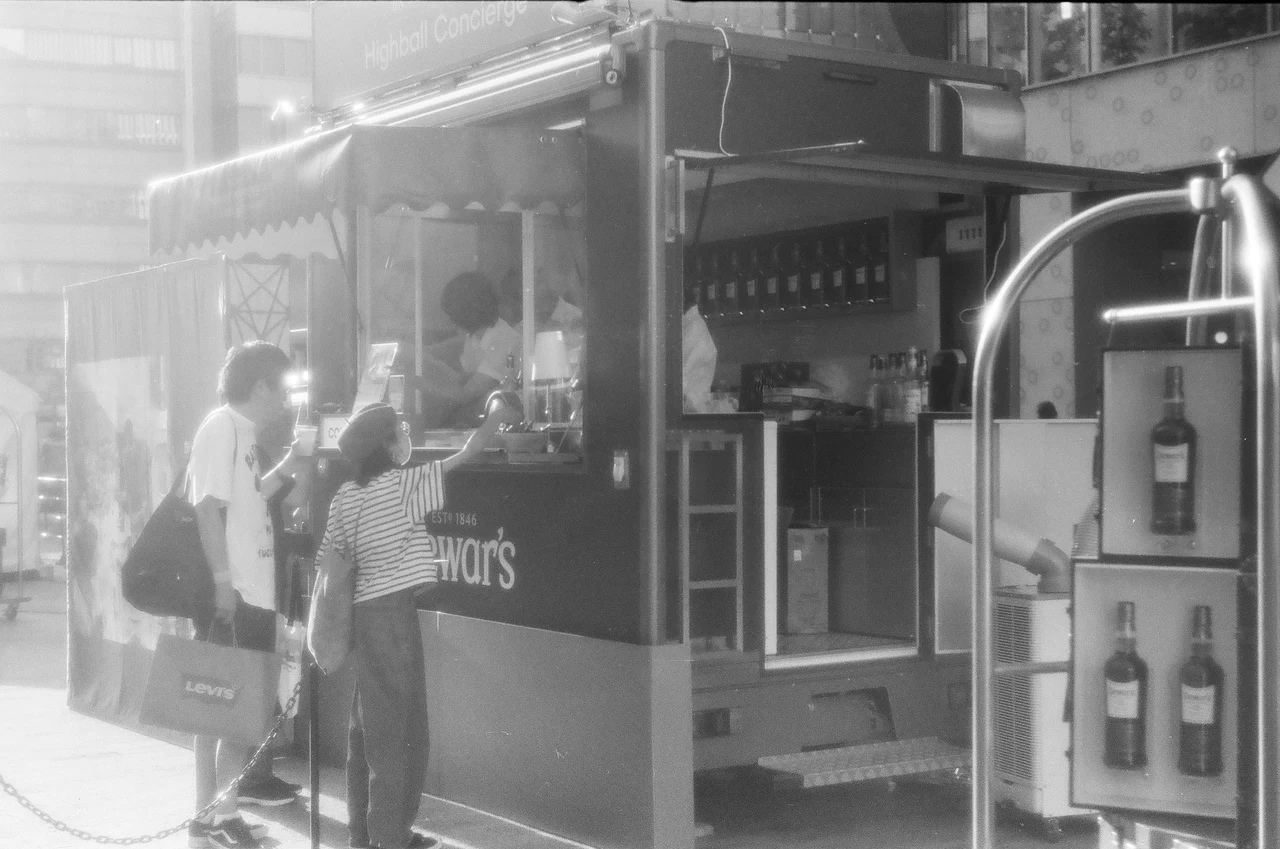 店先に立つ人々と街の光