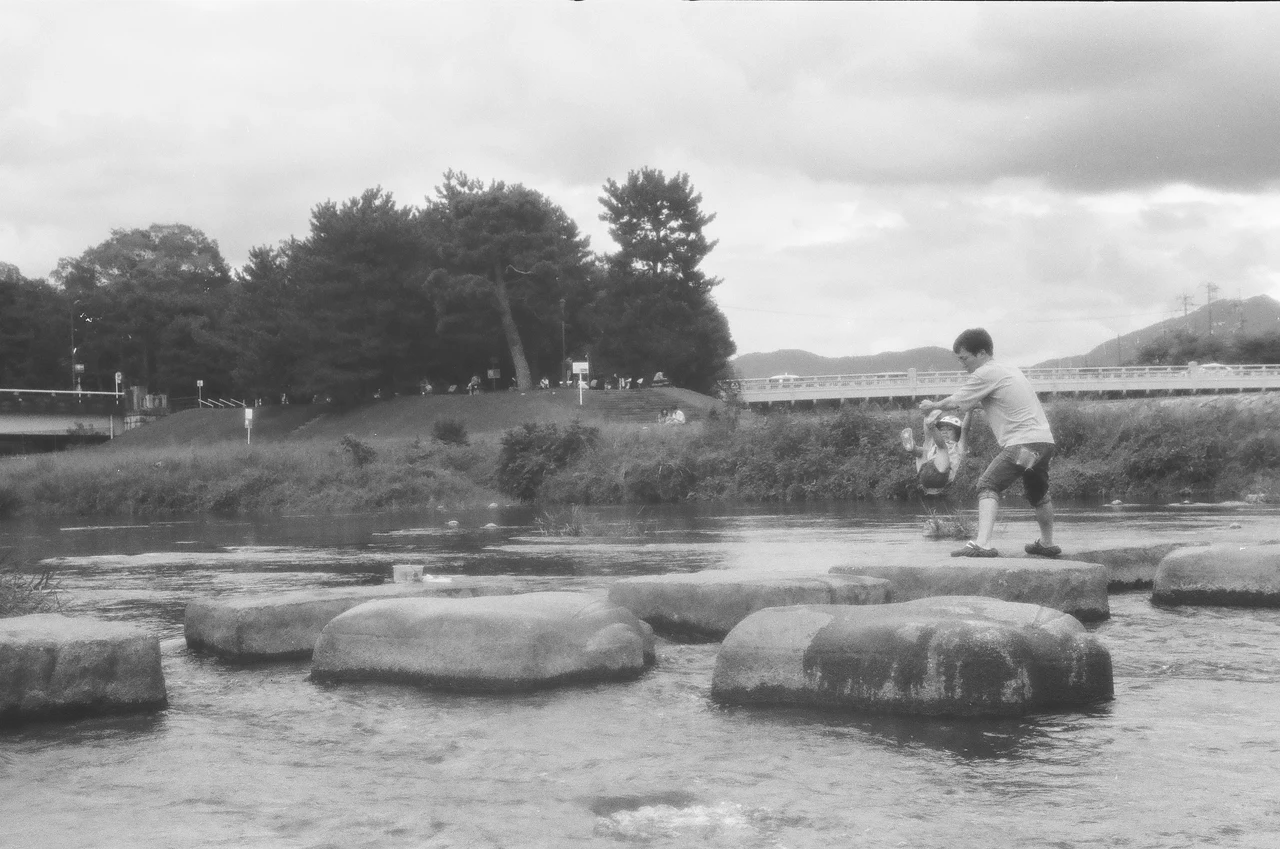 鴨川の飛び石を渡る子ども